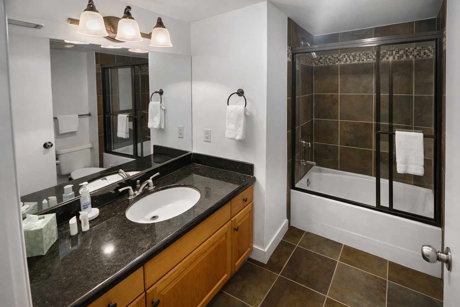 Unwind in your beautifully appointed bathroom with a deep soaking tub, walk-in shower, and black granite countertops. Fresh towels and a peaceful atmosphere await you after each adventure-filled day.