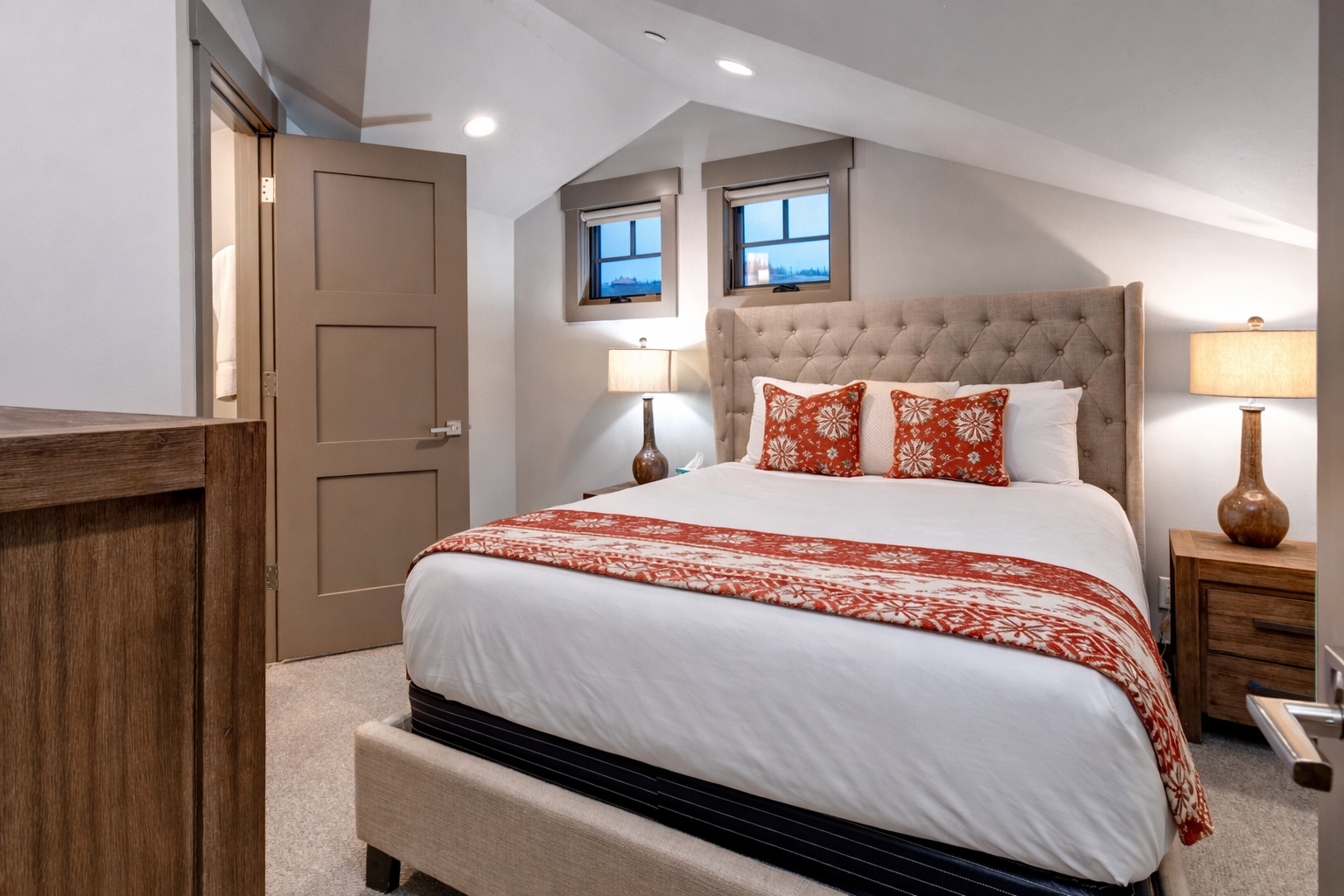 Slip into crisp white linens in your thoughtfully designed bedroom, featuring warm wood accents and a private ensuite where relaxation awaits.