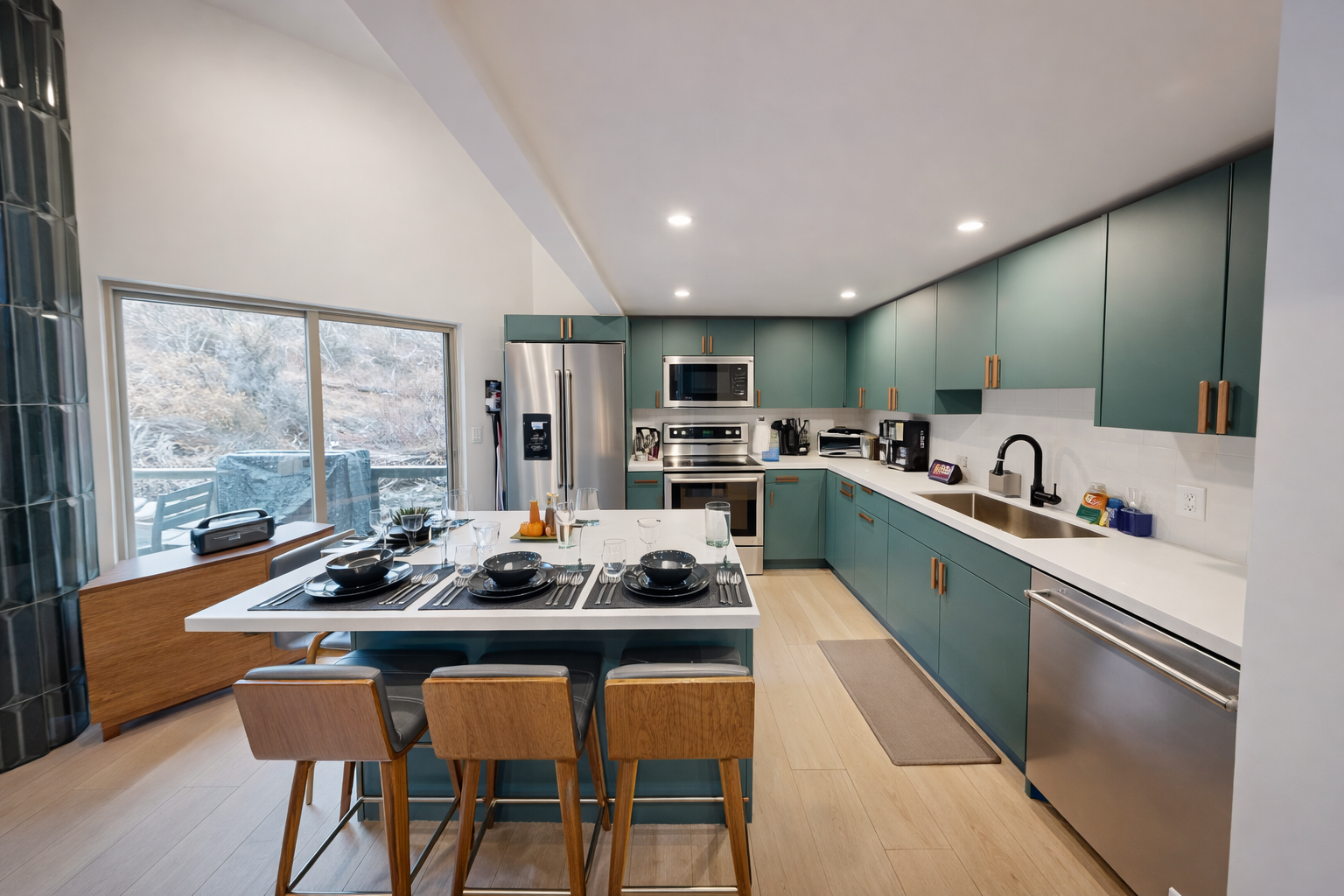 Your modern kitchen features sage green cabinets, white quartz countertops, and a breakfast island perfect for morning coffee while enjoying natural light.