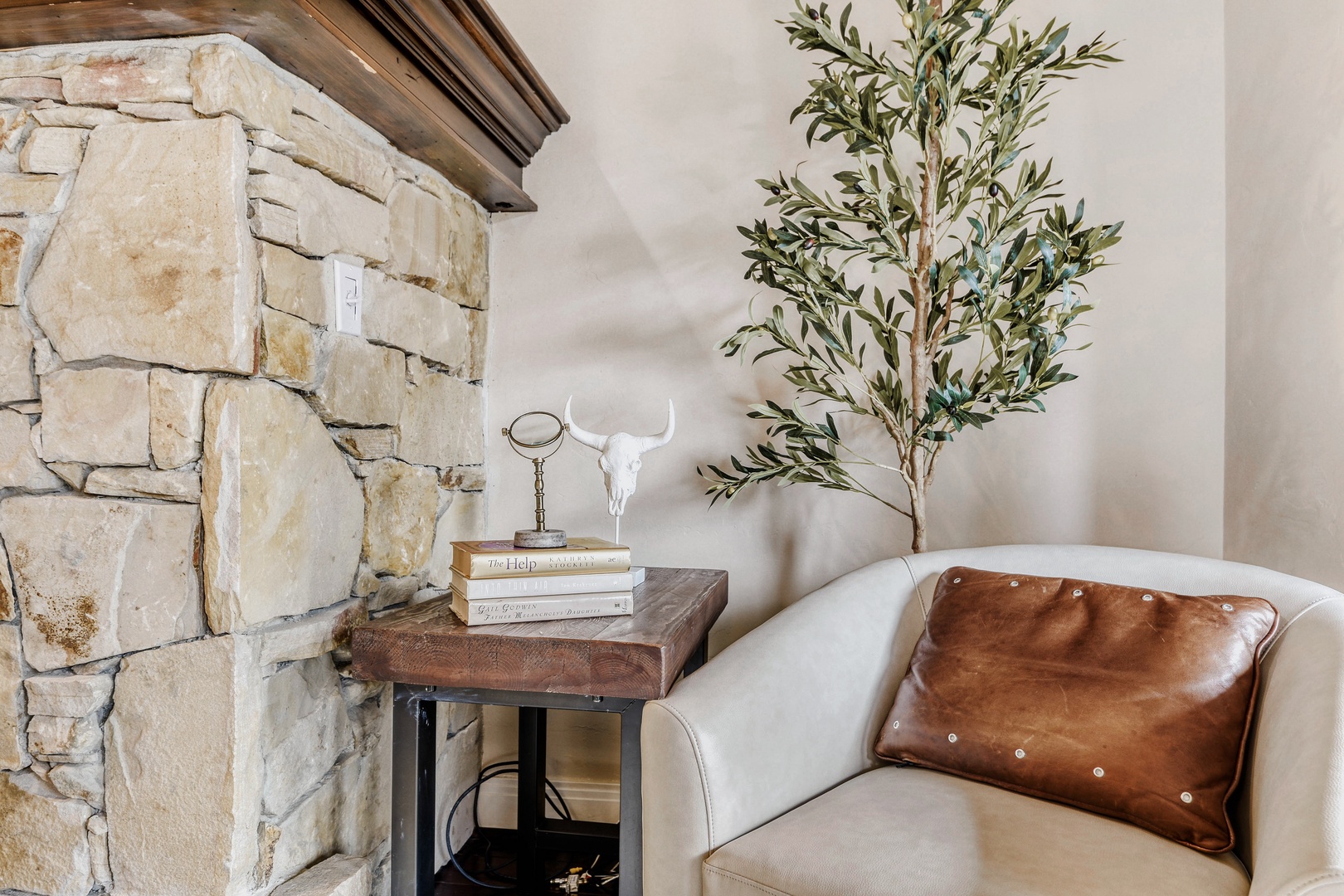 Curl up in your cozy reading nook by the rustic stone fireplace, where thoughtful details create the perfect sanctuary.