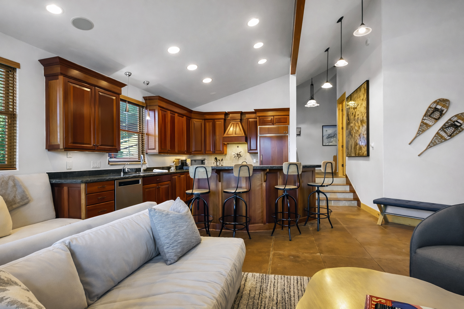 Relax in your open-concept living space where rich wood cabinetry meets modern comfort—perfect for cooking together and unwinding.