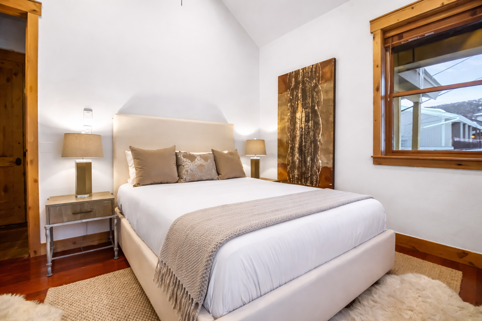 Wake to Alpine views from your cozy bedroom, where rustic wood touches meet plush comfort and warm natural light fills the space.