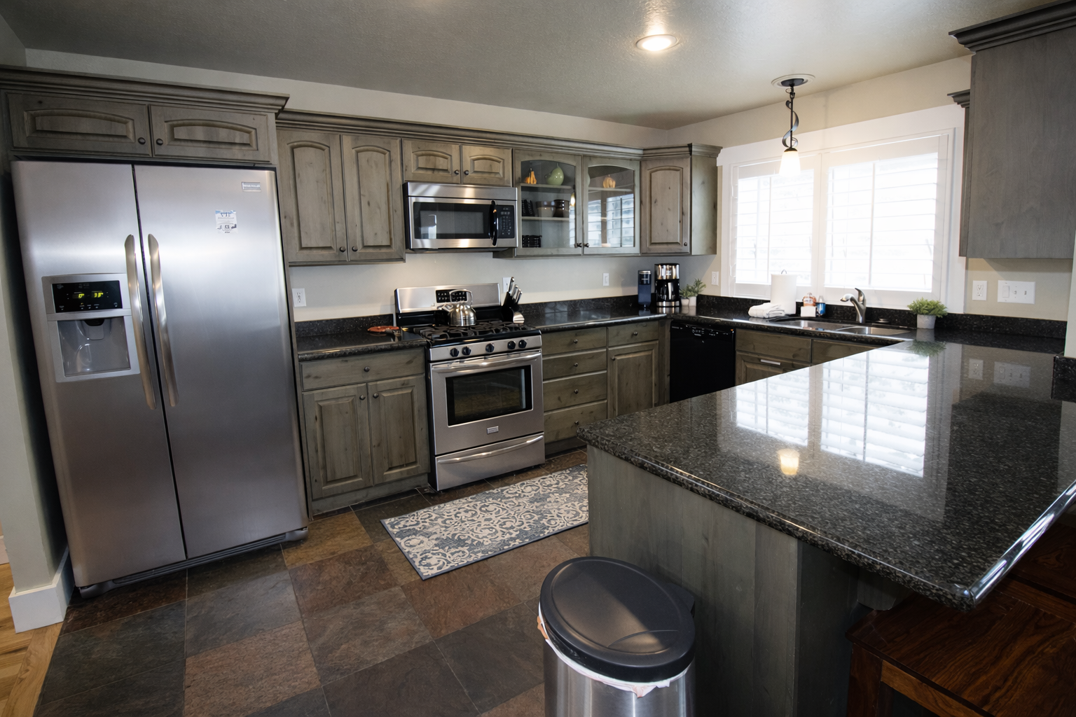 Your fully equipped chef's kitchen features granite countertops, stainless steel appliances, and spacious island for memorable meal prep.