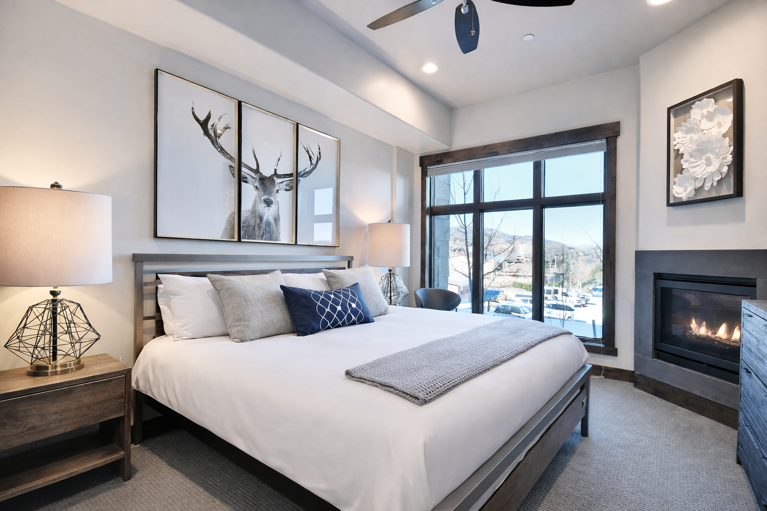 Unwind in your luxurious bedroom featuring a cozy fireplace, mountain views, and modern TV for the perfect alpine retreat experience.