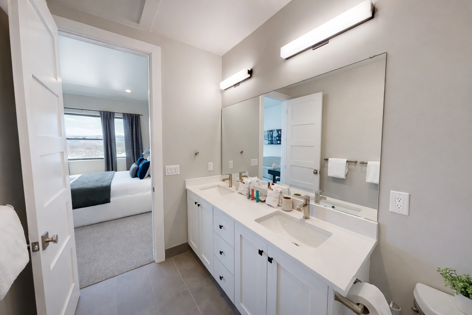 Your ensuite bathroom features elegant dual sinks and modern finishes, connecting seamlessly to your comfortable bedroom retreat.