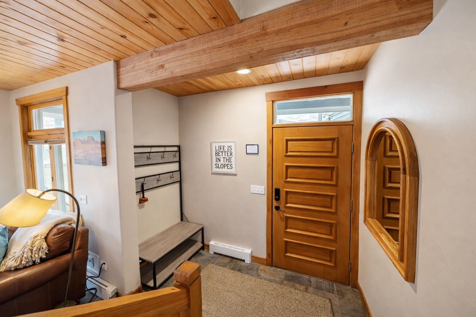 Welcome to your mountain getaway! This cozy entry has space for gear and a bench to prepare for a day on the slopes.