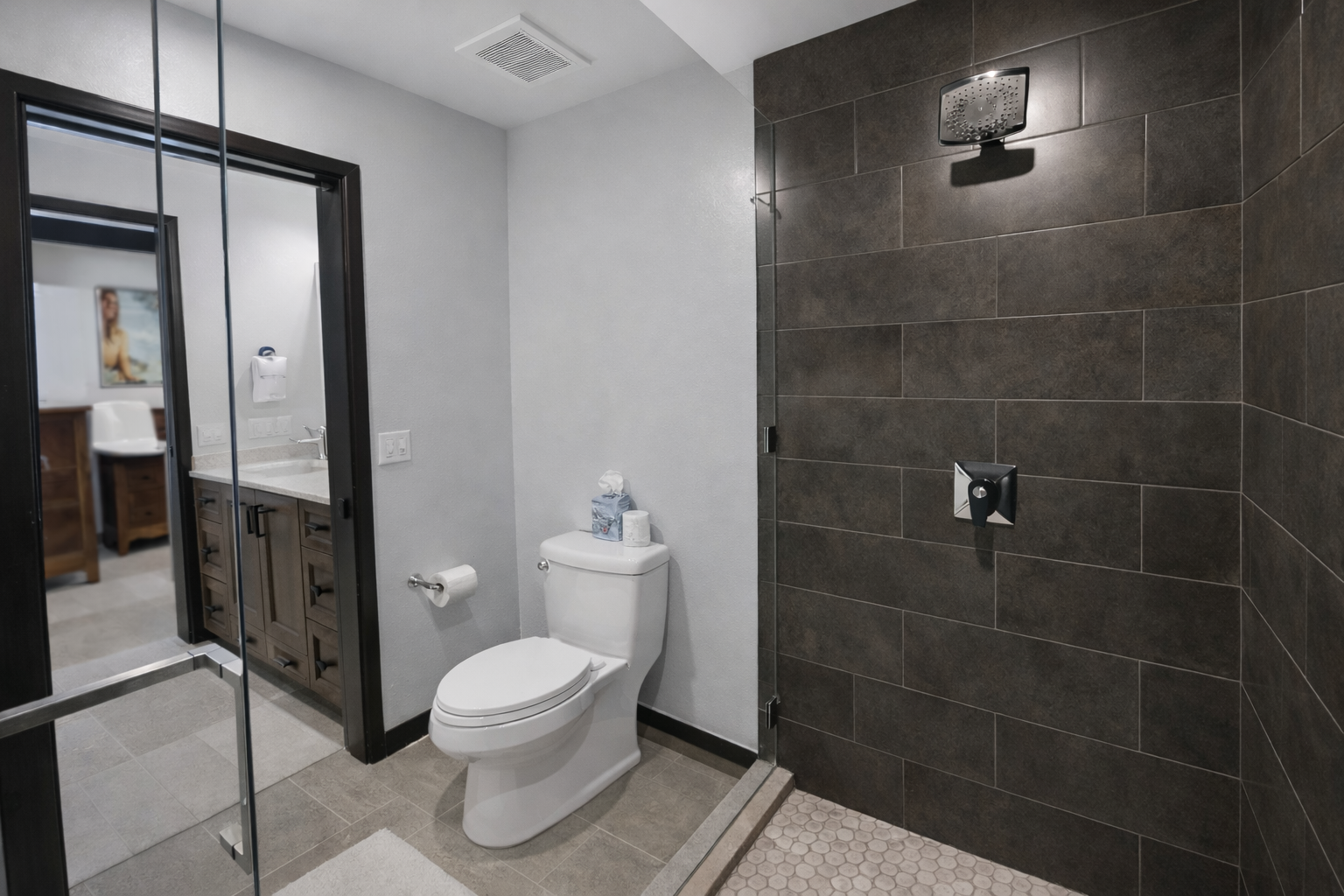 Modern & clean full bathroom with a walk-in shower, large mirror, and quality fixtures. A refreshing space to unwind.