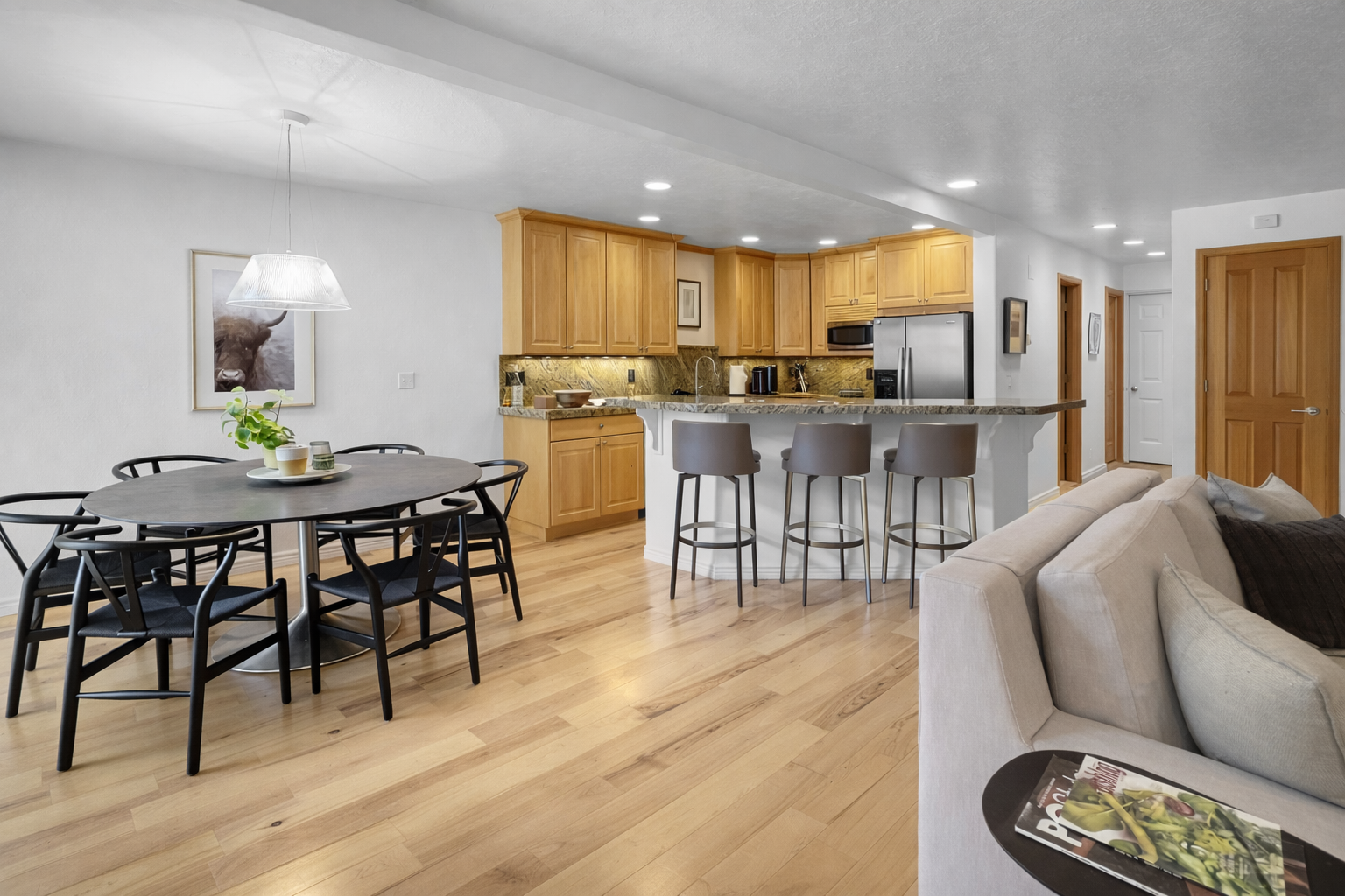 Whip up a feast in this modern, fully-equipped kitchen featuring an open-plan living area, stainless steel appliances, and a stylish breakfast bar, perfect for family dinners and entertaining.