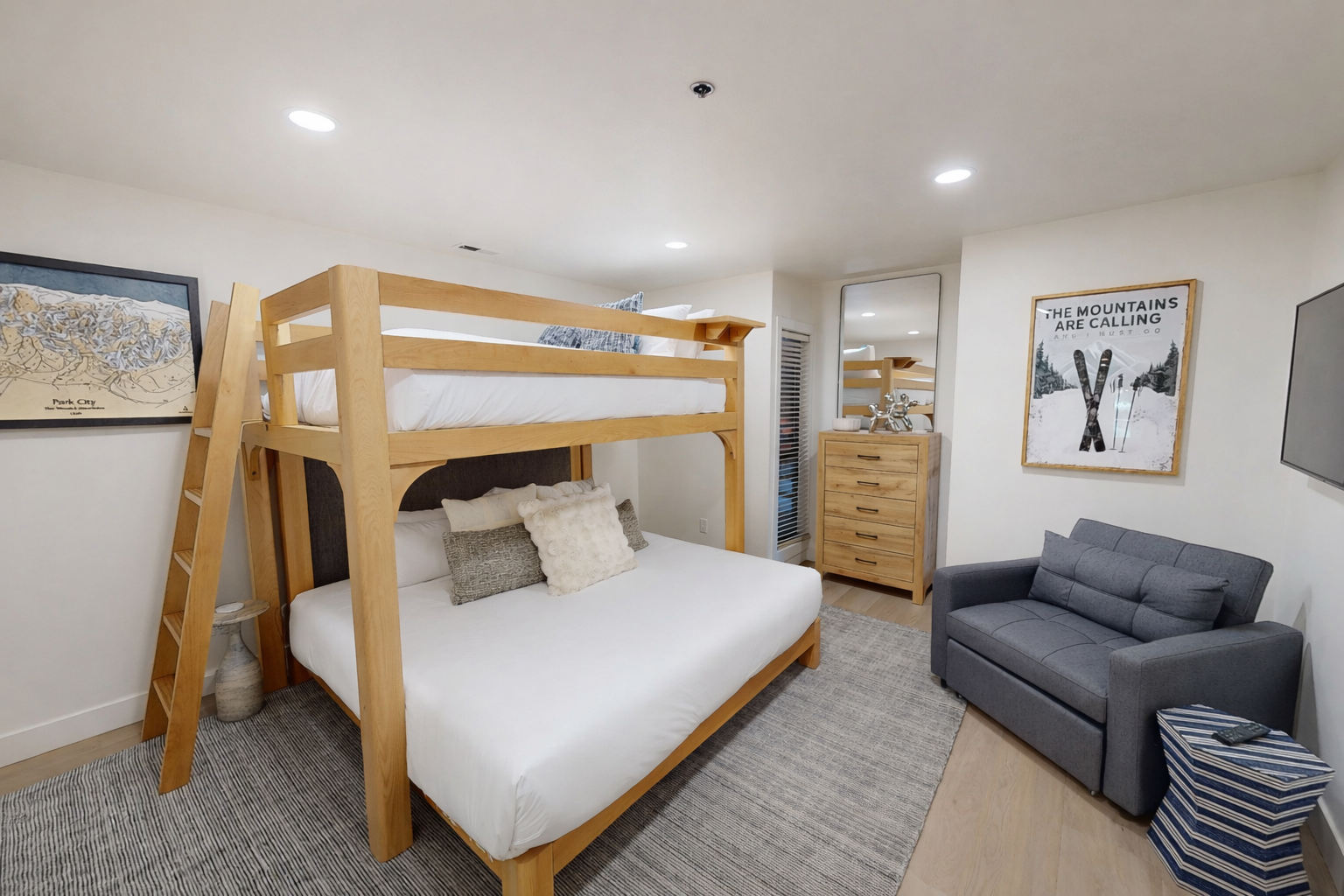 Relax in your bright, modern living space with a large flat-screen TV and comfortable seating, perfect for unwinding after exploring the area.