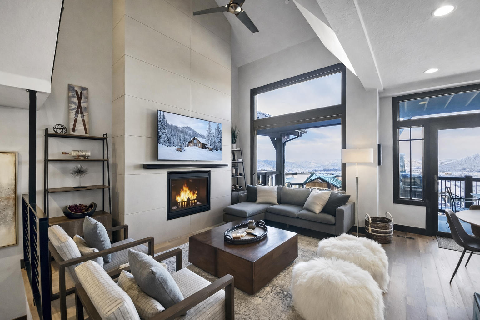 Cozy up by the fireplace in your stylish living room with stunning mountain views and modern comfort.