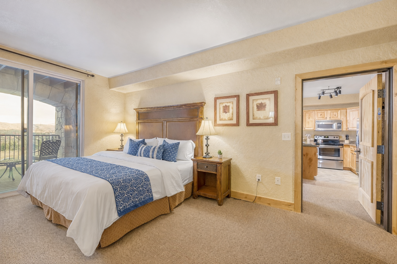 Relax in this spacious master suite featuring a king bed and handcrafted wood furniture. A serene retreat designed for ultimate comfort and a restful night's sleep.