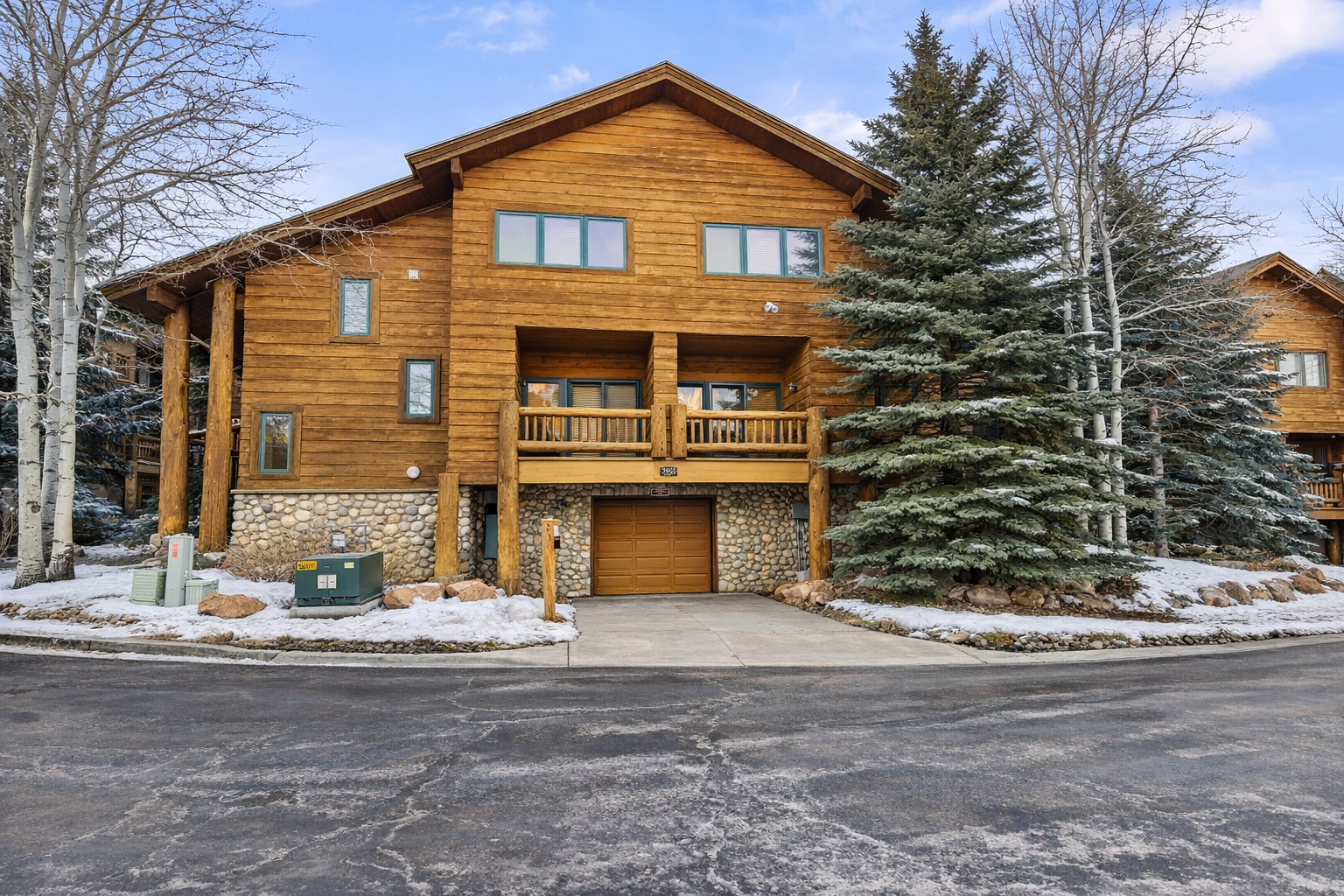 This log-cabin style condo at Timberwolf Lodge offers a scenic setting one mile from the Canyons Village, nestled among aspen trees with a running creek nearby.