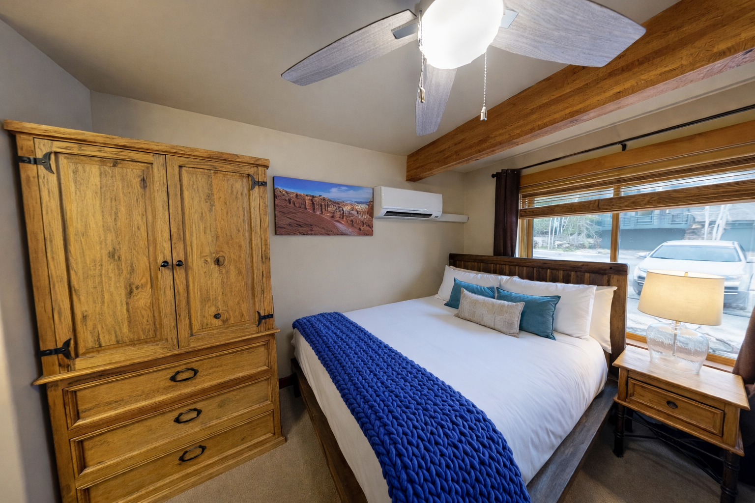 Relax in your cozy twin bedroom with rustic wood beams, crisp linens, and gentle natural light filtering through.