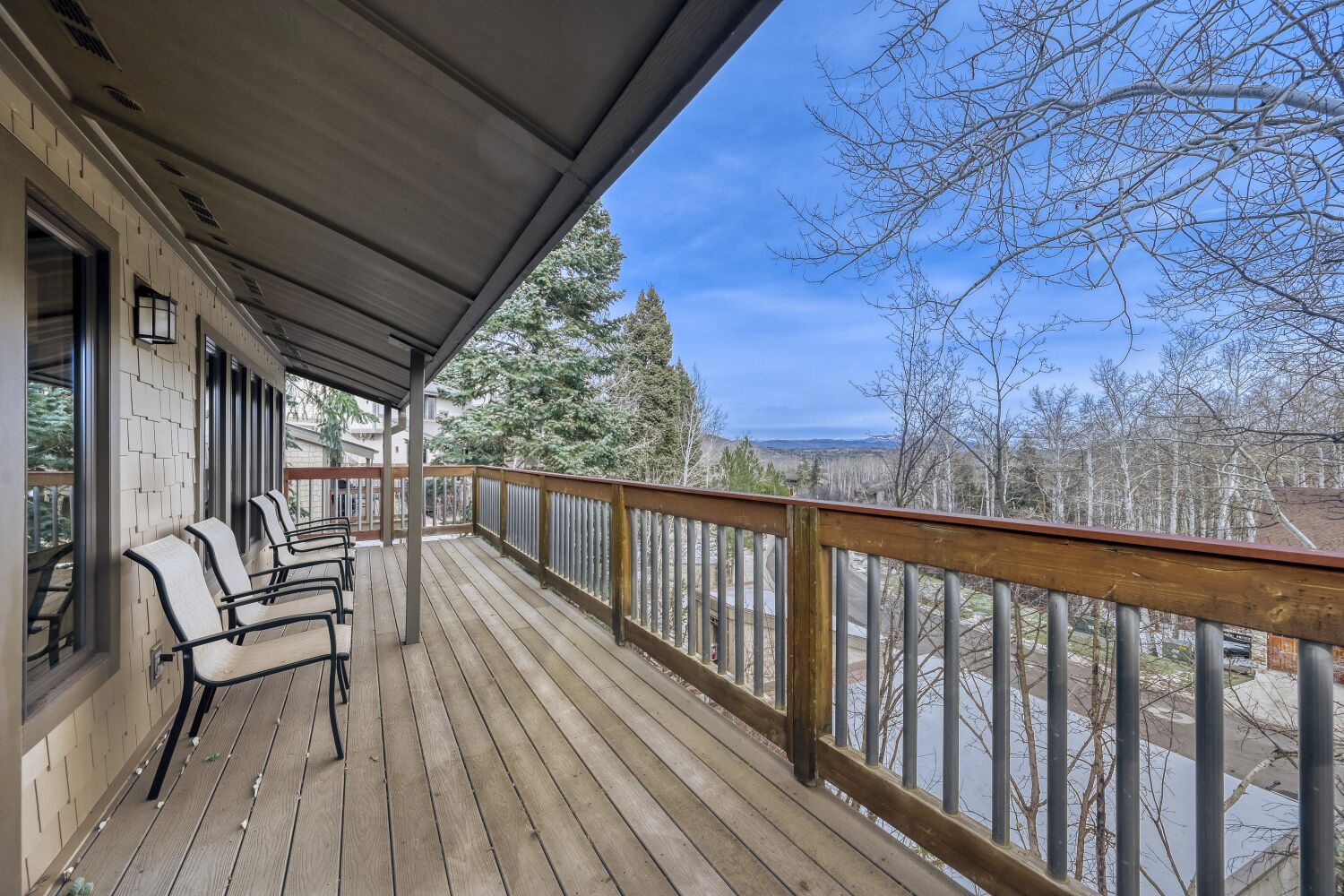 Relax on your private deck with comfortable seating while enjoying peaceful mountain views through the trees.
