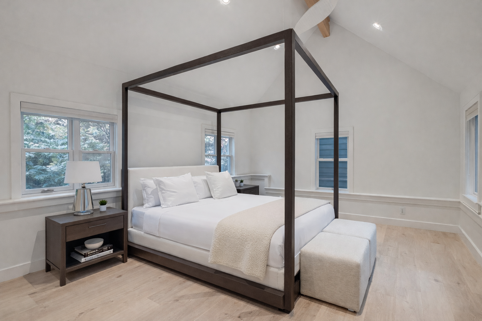 Your modern canopy bed creates a serene sanctuary with clean lines and soft white linens for peaceful nights.