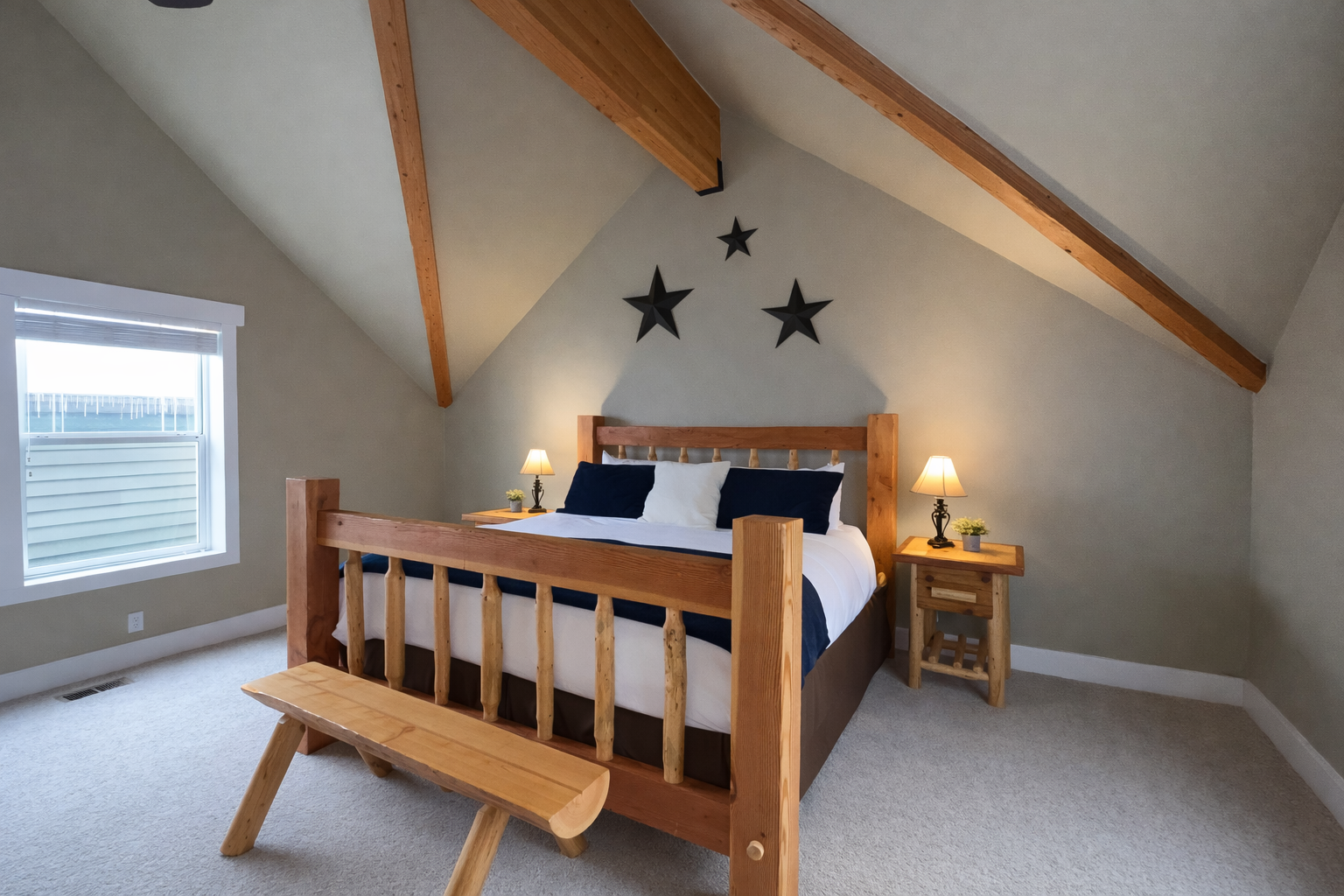 Relax in this spacious master suite on its own private floor. Features include a king-sized log bed, vaulted ceilings, and a large walk-in closet for the ultimate mountain retreat.