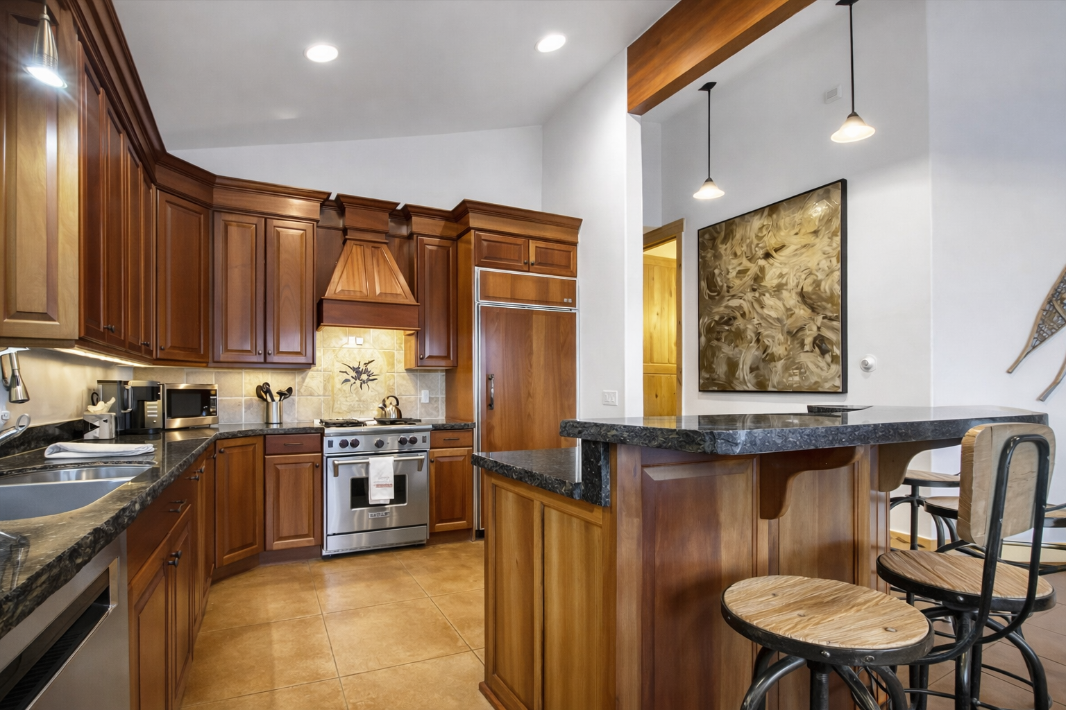 Your gourmet kitchen features rich wood cabinets, granite counters, and professional-grade appliances for memorable culinary adventures.