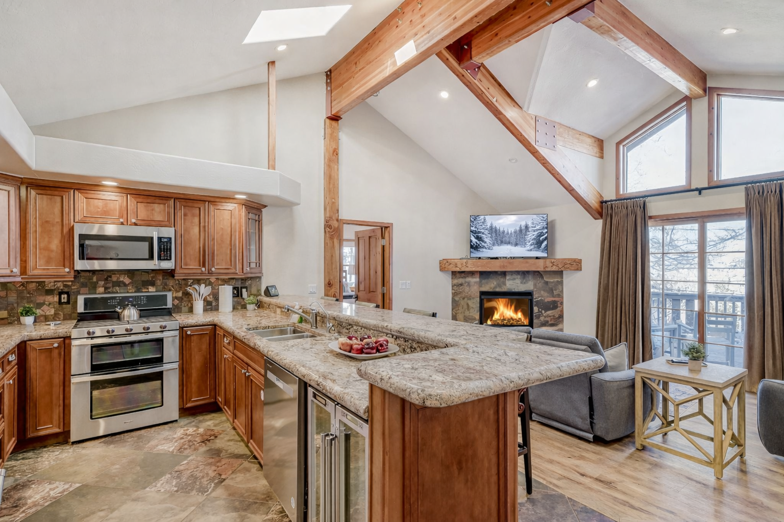 Gather around this open-concept haven where rich wood beams frame your mountain retreat and granite counters invite culinary adventures.