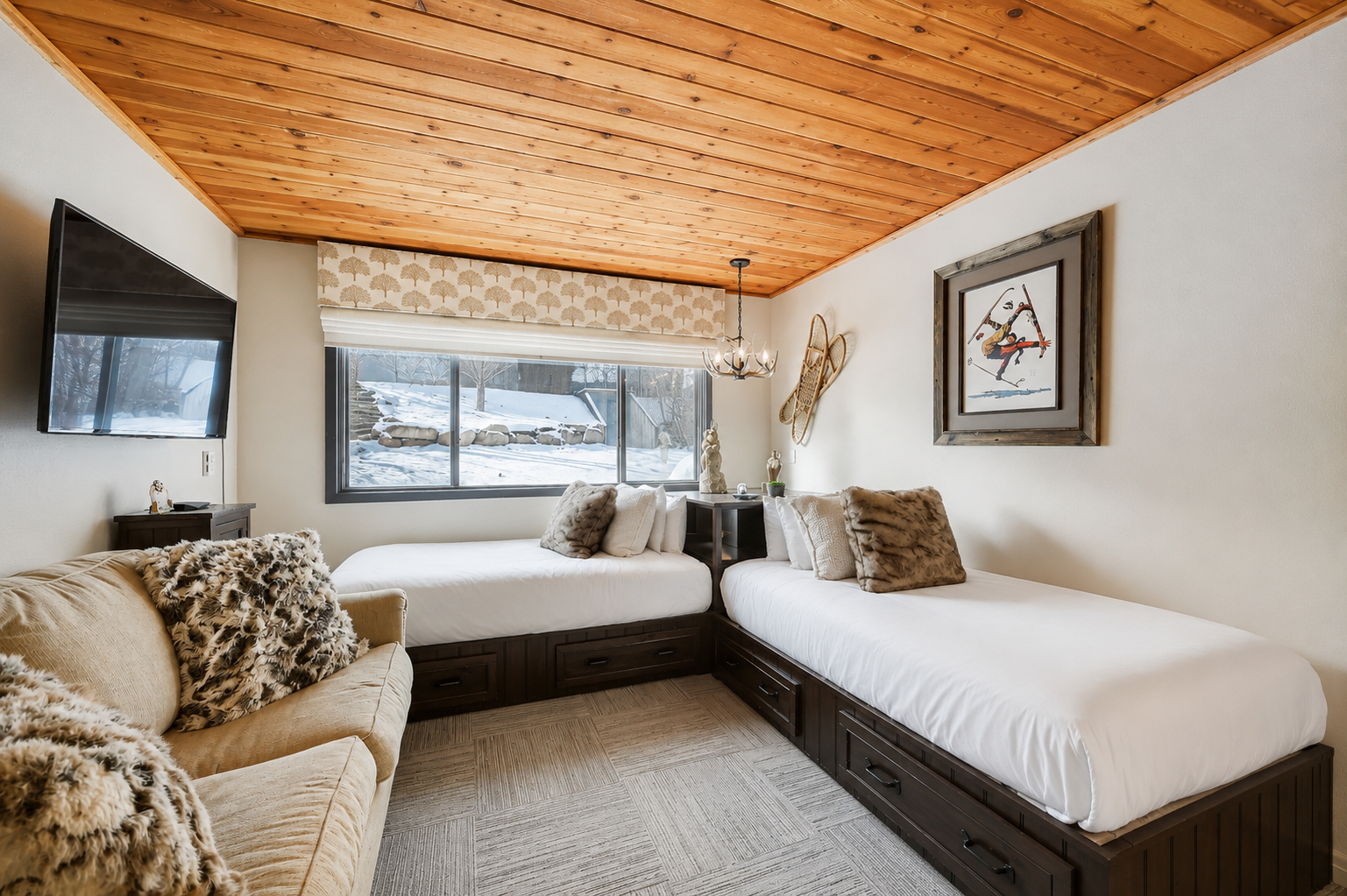 Sink into crisp white linens beneath a warm wood ceiling as snow-dusted winter scenery frames your alpine escape through the window.