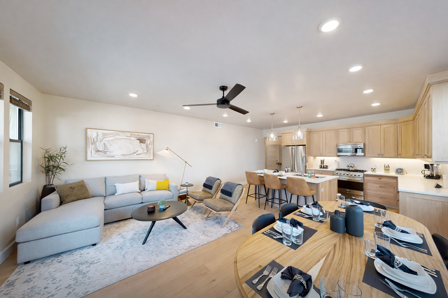 Unwind in this modern Park City living space featuring a sleek stone fireplace, mid-century furnishings, and an open dining area.