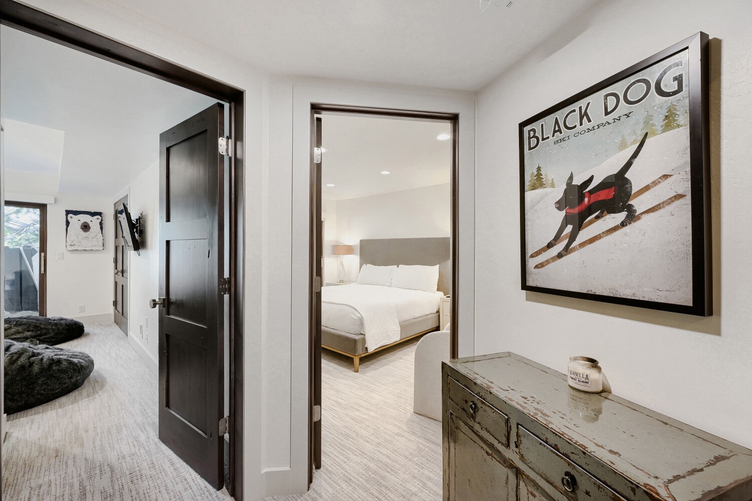 Cozy hallway leads you to your bedroom and more adventures. Vintage furniture and playful ski-lodge art create a welcoming, relaxed vibe throughout your space.