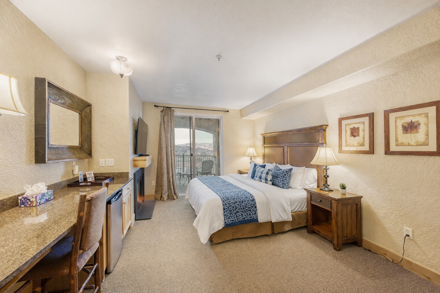 Relax in this spacious master suite featuring a king bed and handcrafted wood furniture. A serene retreat designed for ultimate comfort and a restful night's sleep.