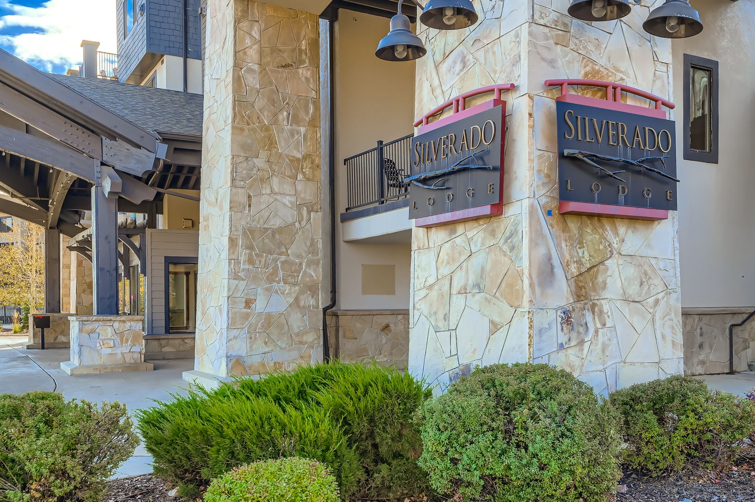 Silverado Lodge entrance showcases elegant stone architecture and professional signage in a well-maintained mountain resort setting.