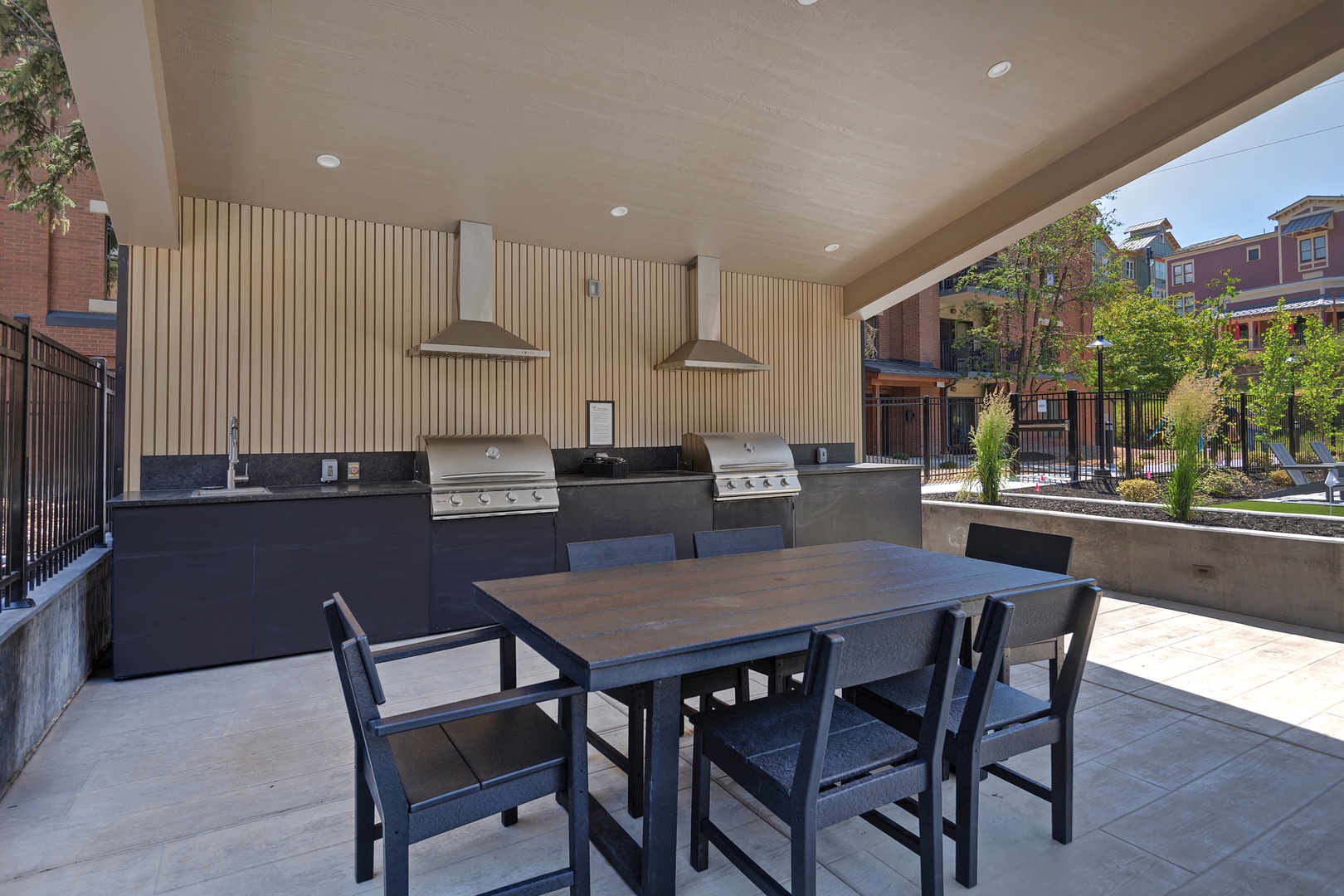 Fire up the grill and gather around the outdoor dining table in this covered BBQ area, perfect for al fresco meals with friends and family.