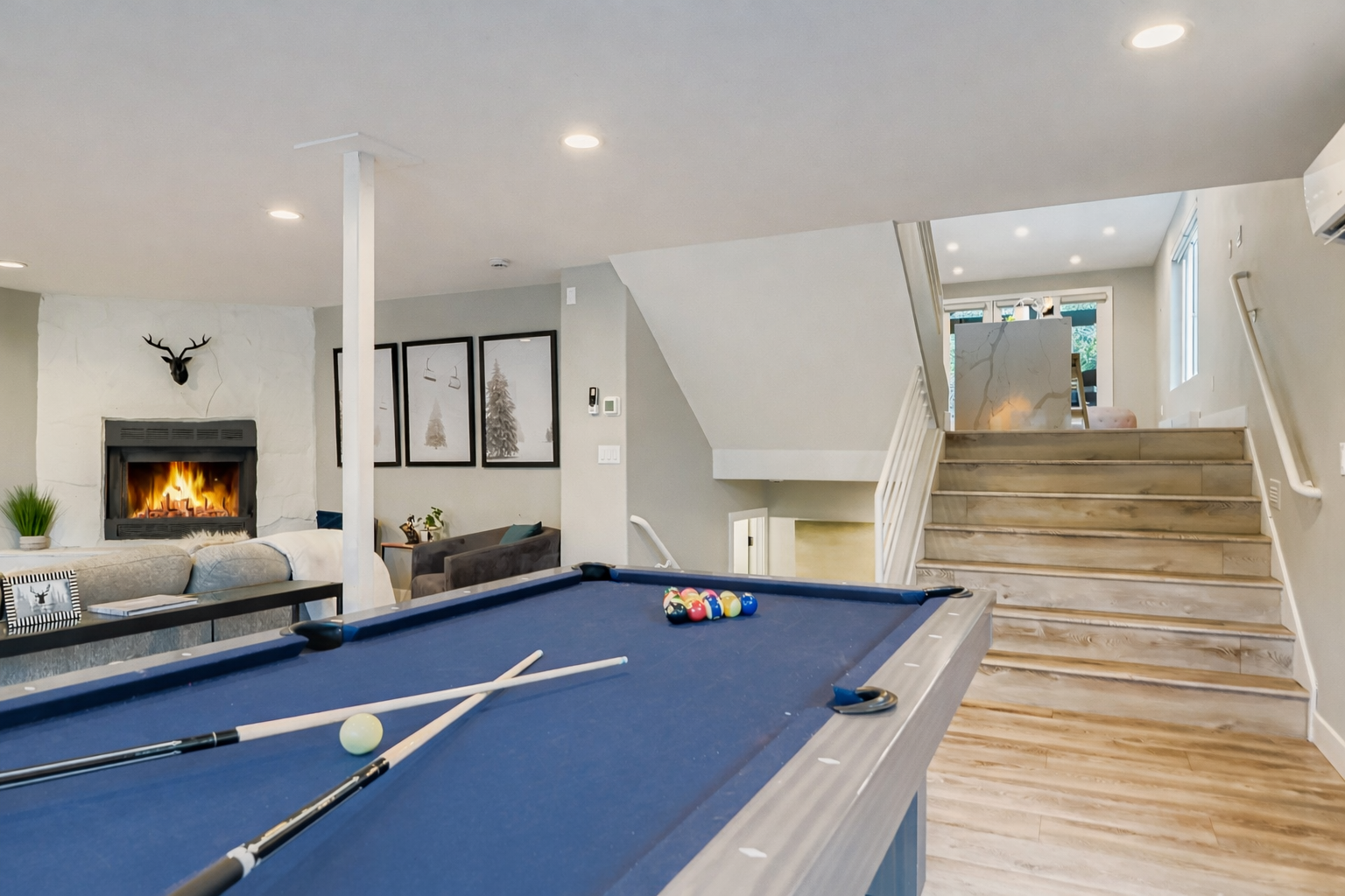 Challenge your guests to a game of pool in this fun downstairs game area! The open space also features cozy seating and a fireplace for relaxing.