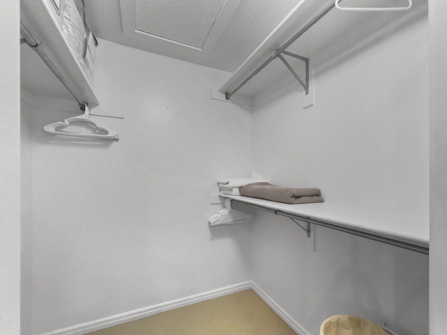 A spacious walk-in closet with convenient hanging rods and a built-in shelf to keep your wardrobe organized and within reach during your stay.