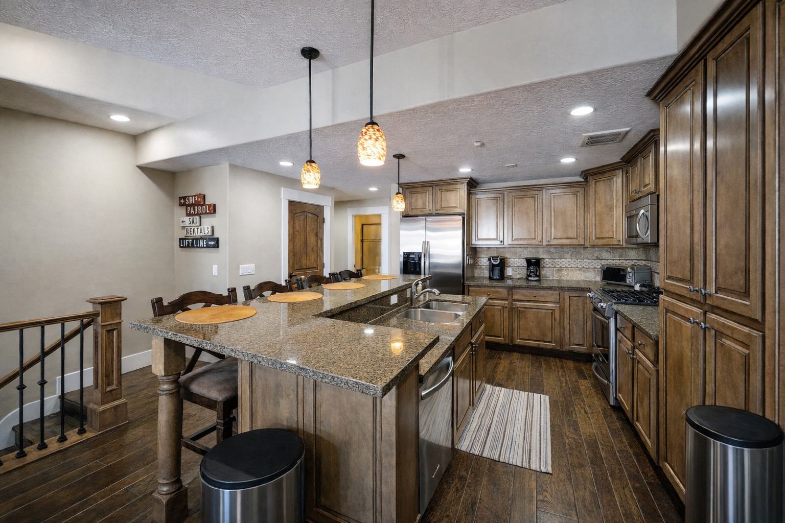 Prepare a gourmet meal in this warm, inviting kitchen featuring rich wood cabinetry and a spacious breakfast bar with seating for four.