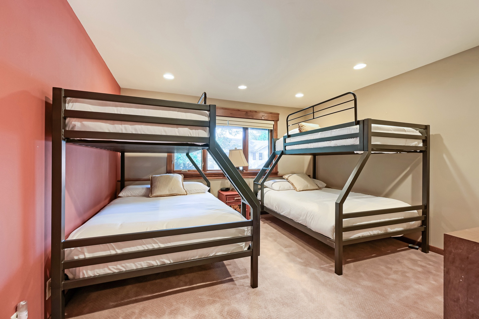 Two sturdy bunk beds create a cozy spot for kids or friends to share laughter and settle in after a day of adventure. Natural light from the window brightens your space while crisp linens promise restful sleep.