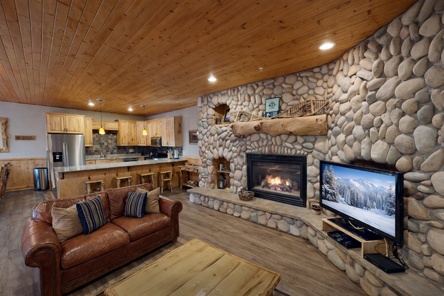 Curl up by your crackling stone fireplace while enjoying mountain views on the big screen—rustic luxury awaits.