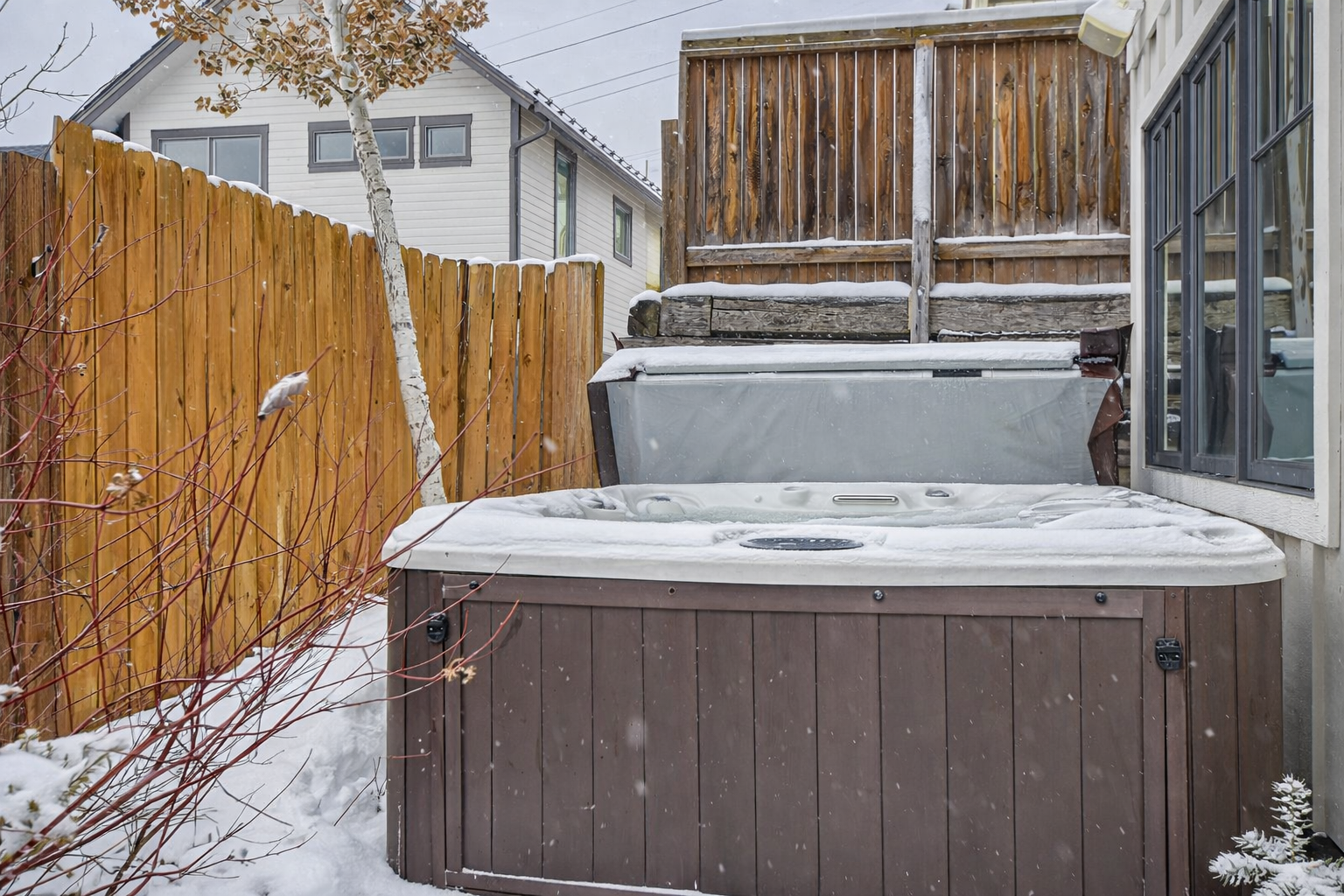 Unwind in your private hot tub surrounded by winter's beauty - the perfect way to warm up after snowy adventures.