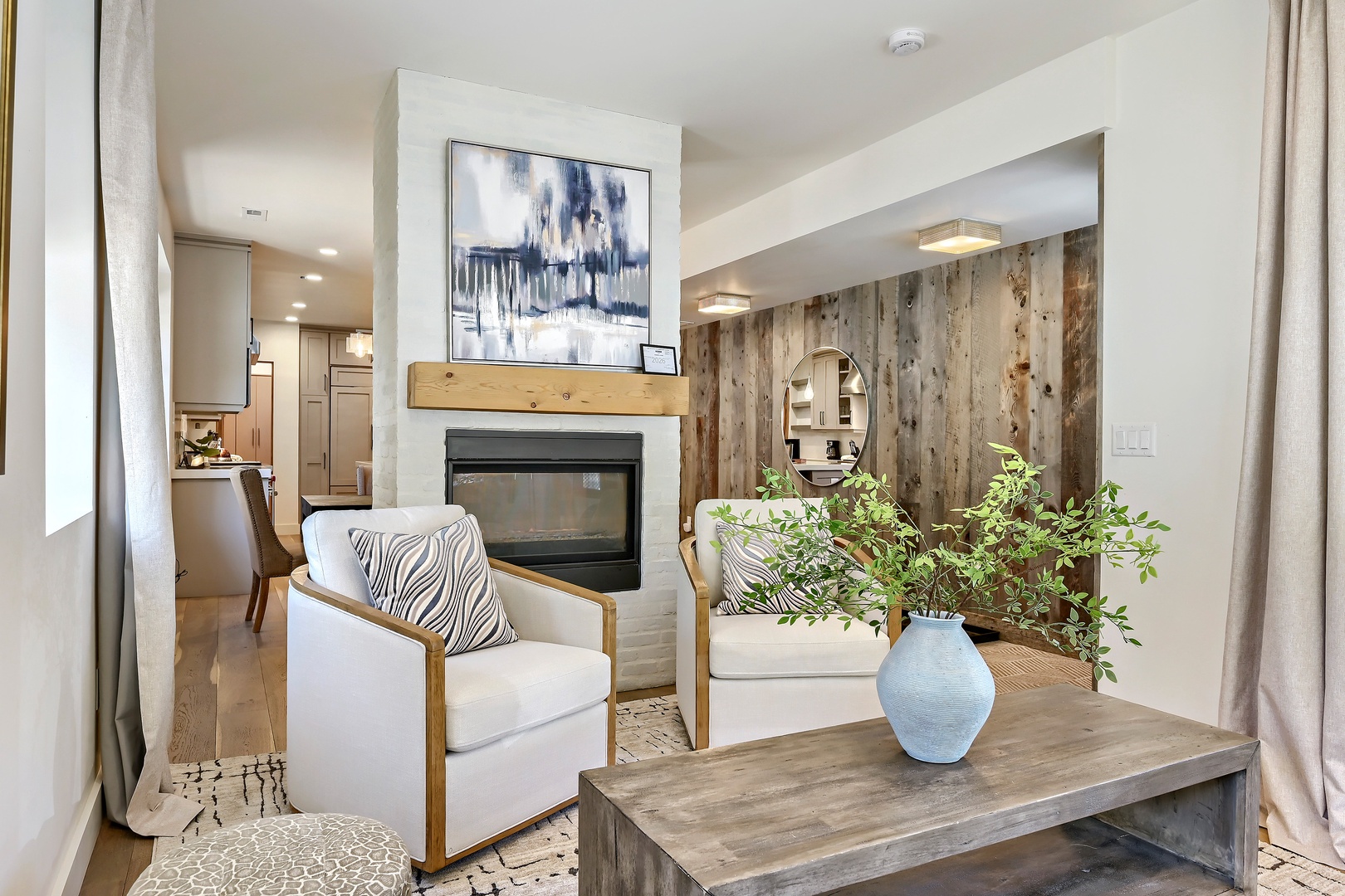 Picture yourself unwinding in these cozy armchairs, warmed by the glow of your private fireplace. Natural textures and modern comfort blend to create your perfect retreat after a day exploring.