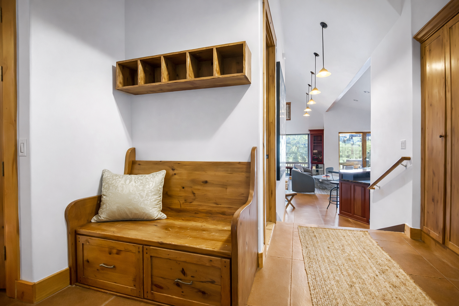 Step into your warm welcome nook with custom wooden storage bench and cubbies, perfect for settling in after your adventures. Unit A