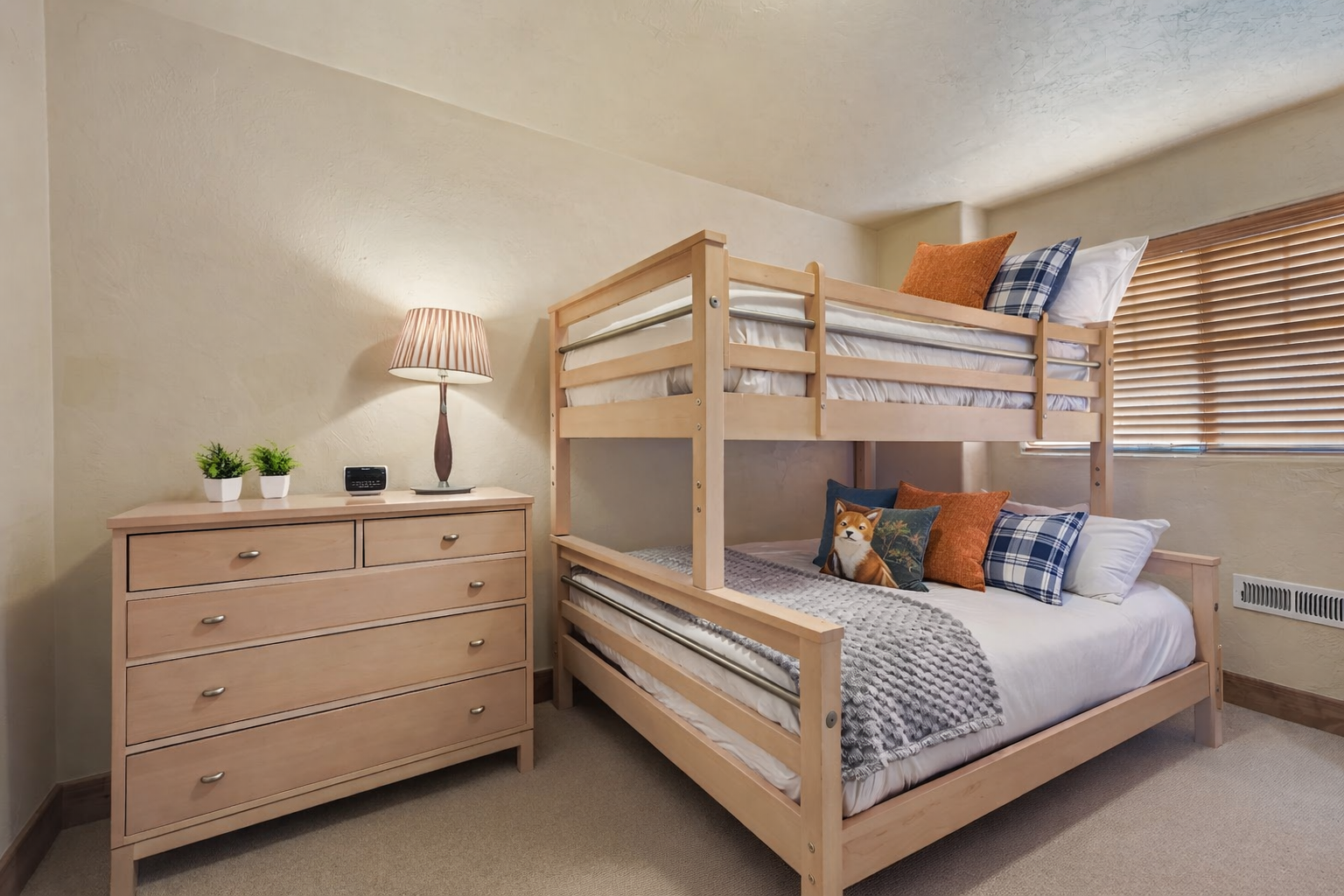 Your comfortable bunk bed room features space-saving design with cozy bedding, ample storage, and a warm, welcoming atmosphere perfect for families or groups.