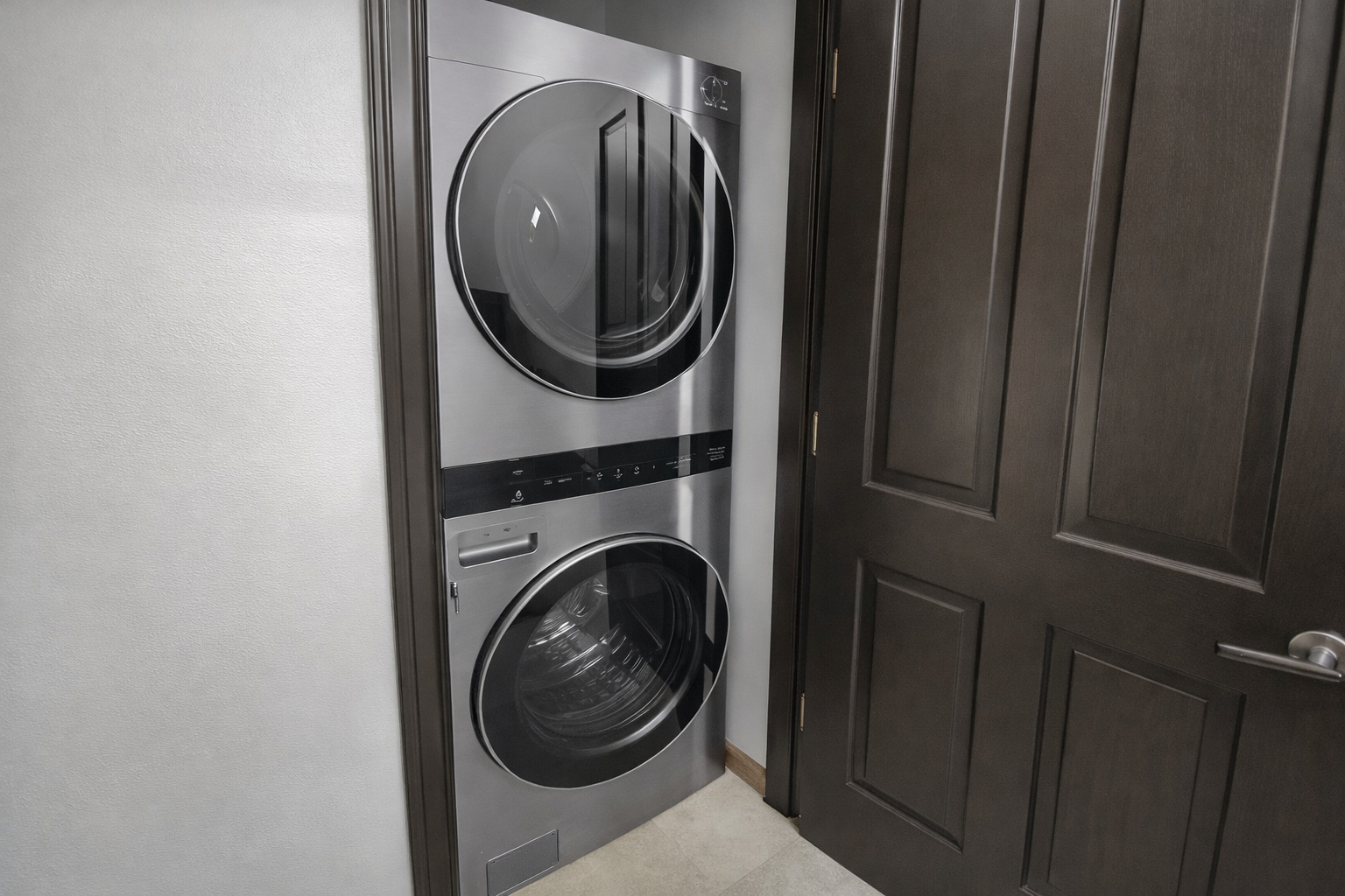 Modern in-unit laundry with a sleek stacked washer and dryer unit. Perfect for keeping your gear fresh during your stay.