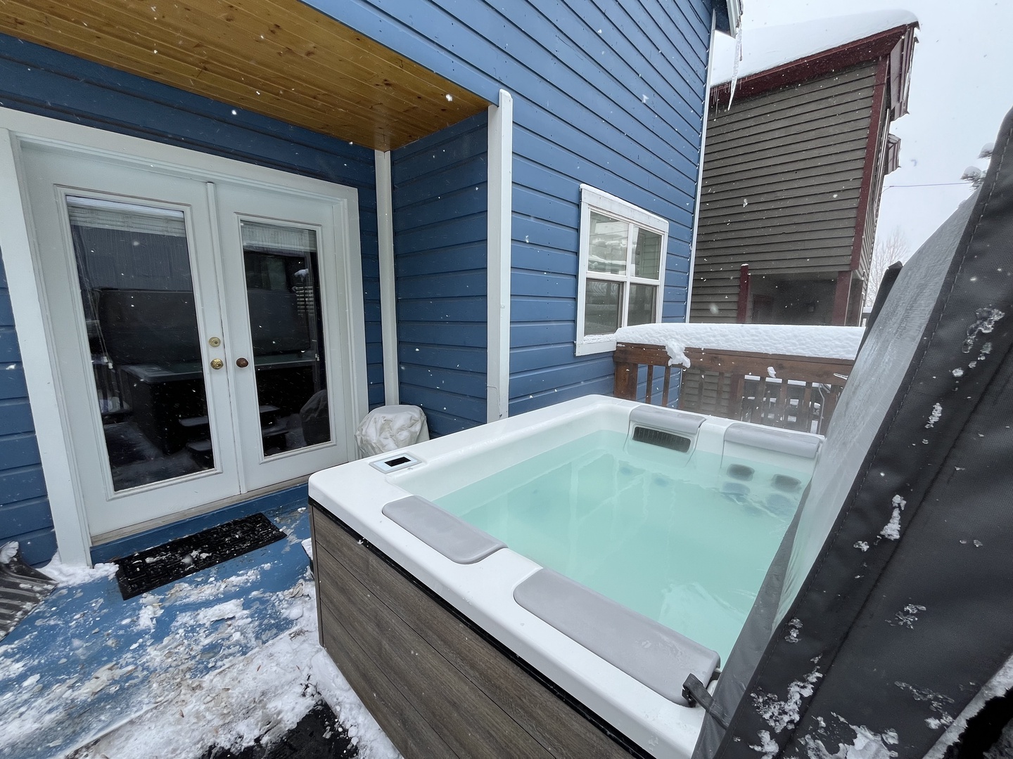 Unwind in this serene winter oasis featuring a private, steaming hot tub on a snowy deck. Perfect for après-ski relaxation, this cozy retreat offers the ultimate seasonal escape.