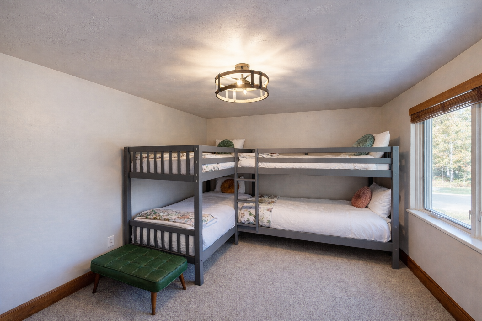 Sleep soundly in this fun bunk room! With two sets of comfortable bunk beds, a TV, and a cheerful green dresser, it's the perfect cozy spot for a great group stay.