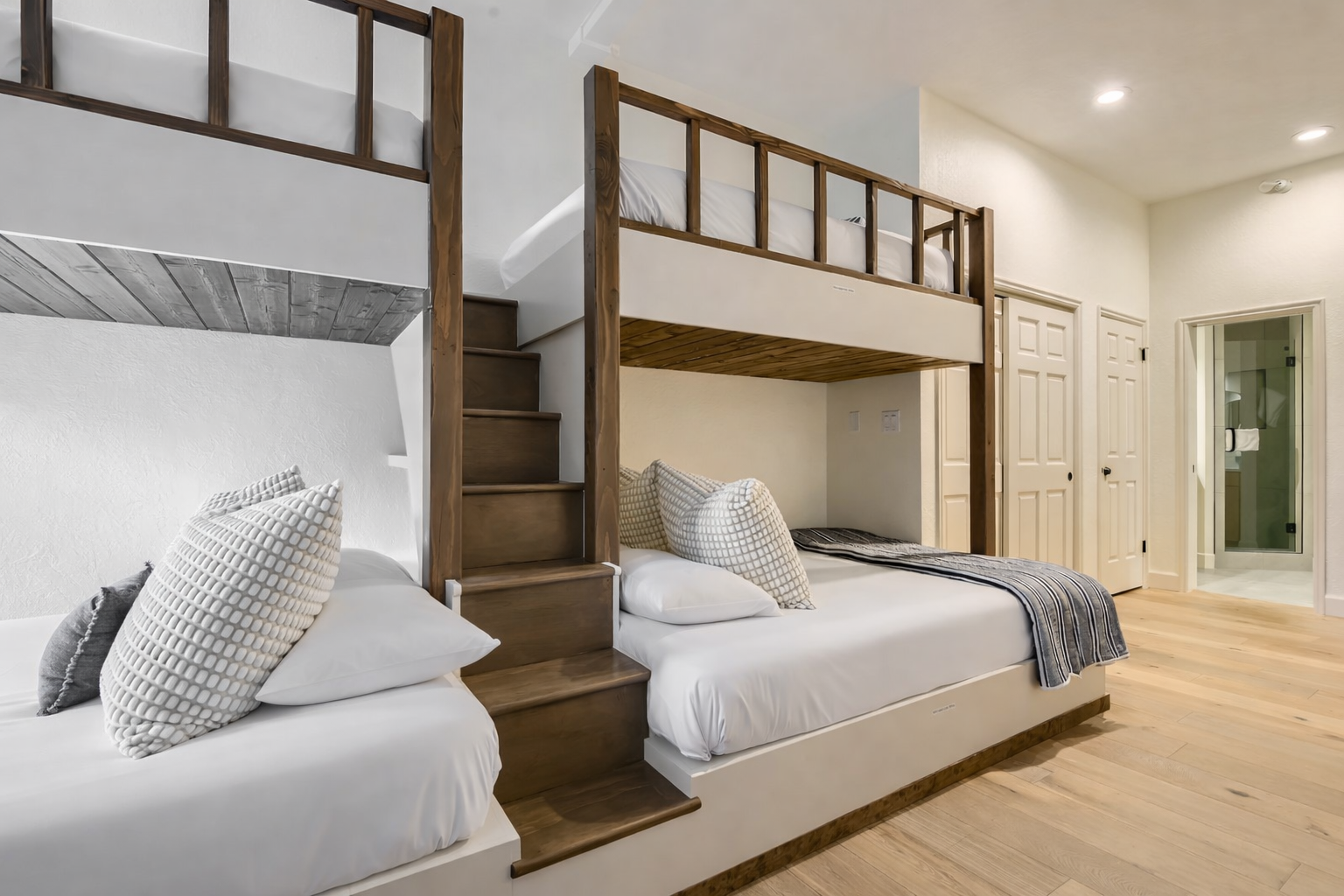 Sleep peacefully in your stylish bunk beds with crisp linens and cozy pillows in this bright, modern bedroom.