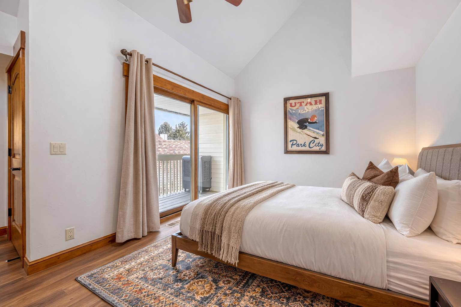 Sink into crisp linens and soft throws in your peaceful bedroom, where warm wood floors and natural light create the perfect retreat.