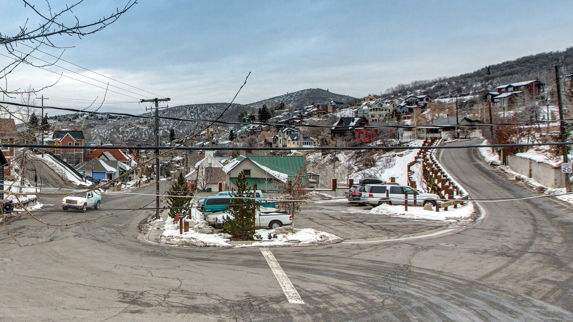 Charming winter mountain town with snow-dusted hillsides and cozy residential neighborhoods creating a perfect seasonal escape.