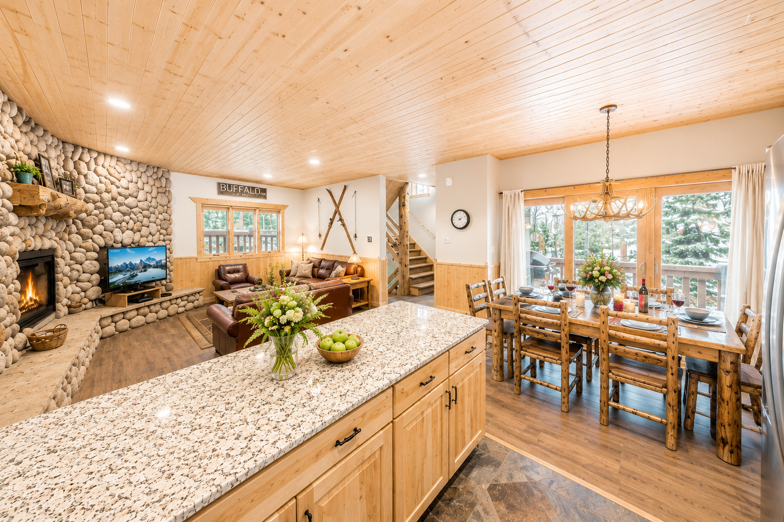 Step into your warm mountain retreat with stunning wood ceilings, a cozy stone fireplace, and open-concept living perfect for gathering with loved ones after a day of adventure.