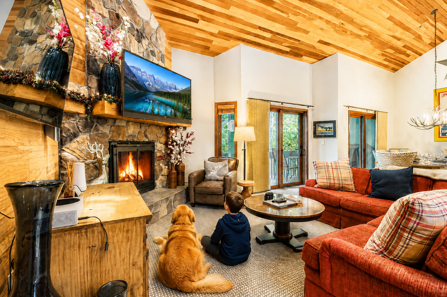 Gather around the stone fireplace with your family and favorite furry friend, soaking up the cozy warmth beneath stunning wood-beamed ceilings in this inviting mountain retreat.