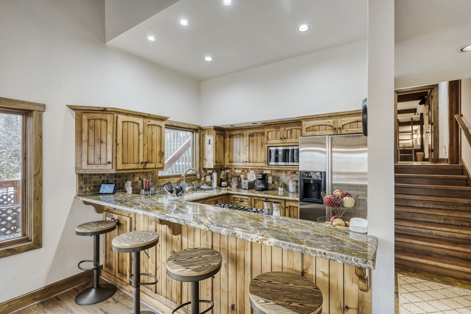 Gather around your spacious granite island for morning coffee or evening meals in this warm, rustic kitchen with modern appliances.