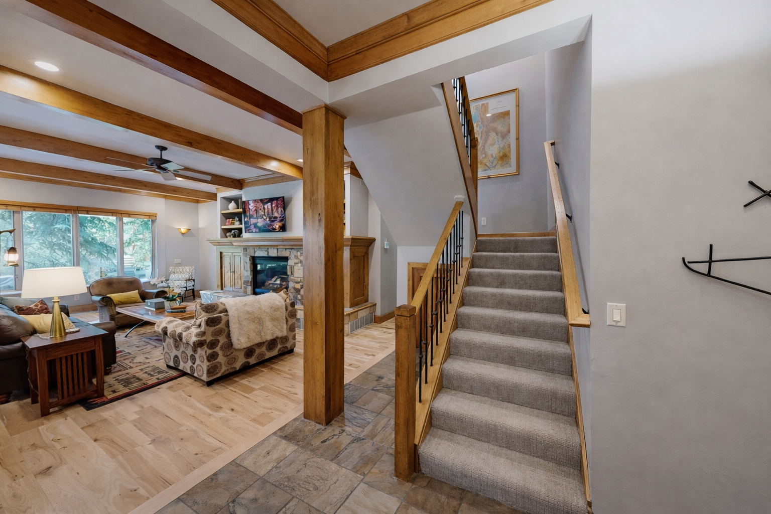 Settle into your inviting living space with exposed beams, cozy fireplace, and comfortable seating perfect for relaxing evenings together.