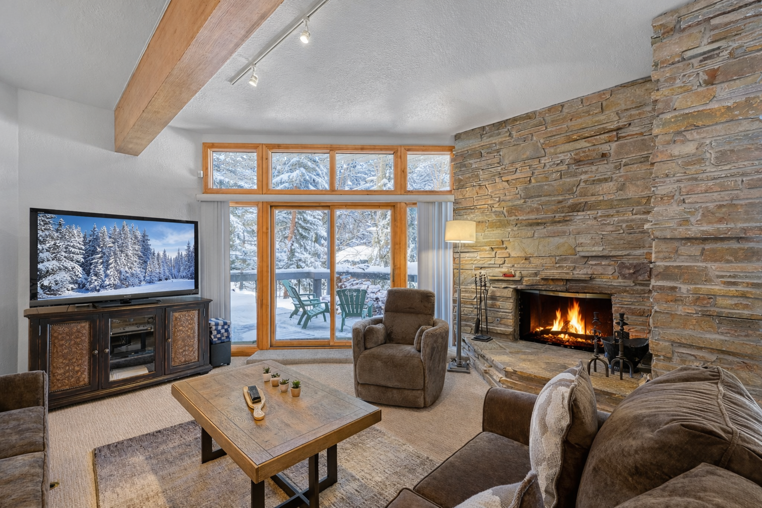 Cozy up by the crackling fireplace while snow blankets the mountain landscape outside your windows, creating the perfect winter retreat atmosphere.