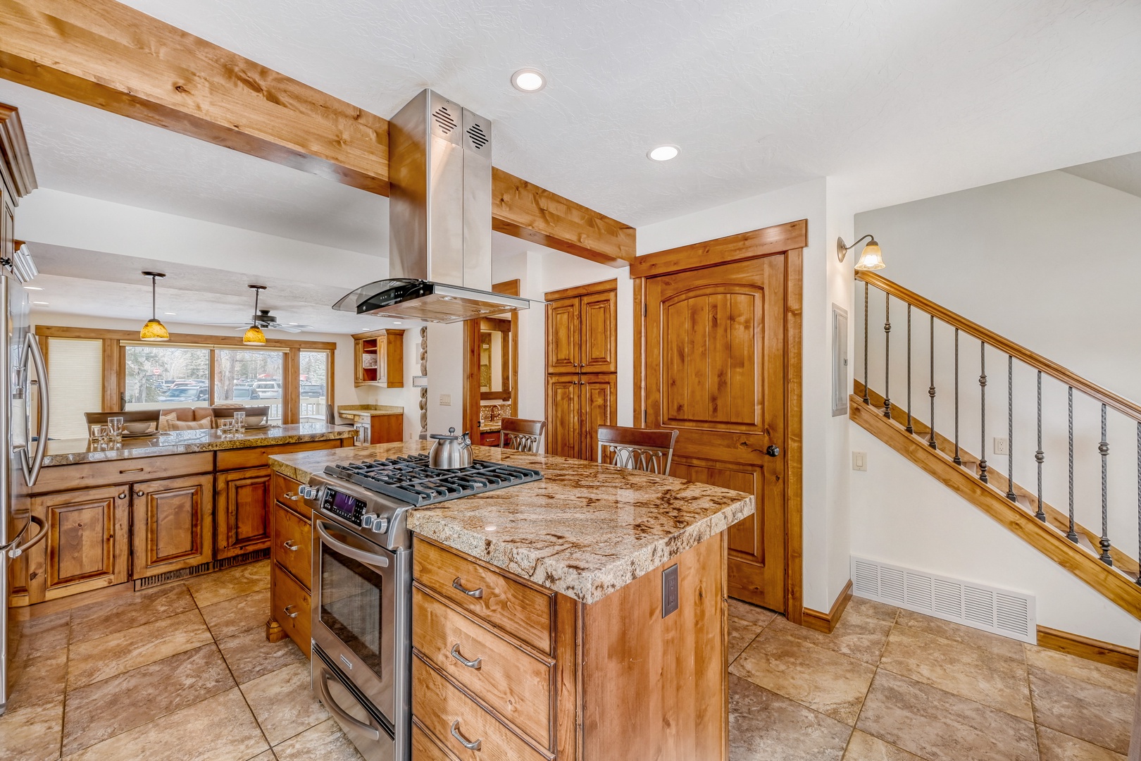 Your gourmet kitchen features granite counters, gas range, and rustic wood cabinetry - perfect for creating memorable meals together.