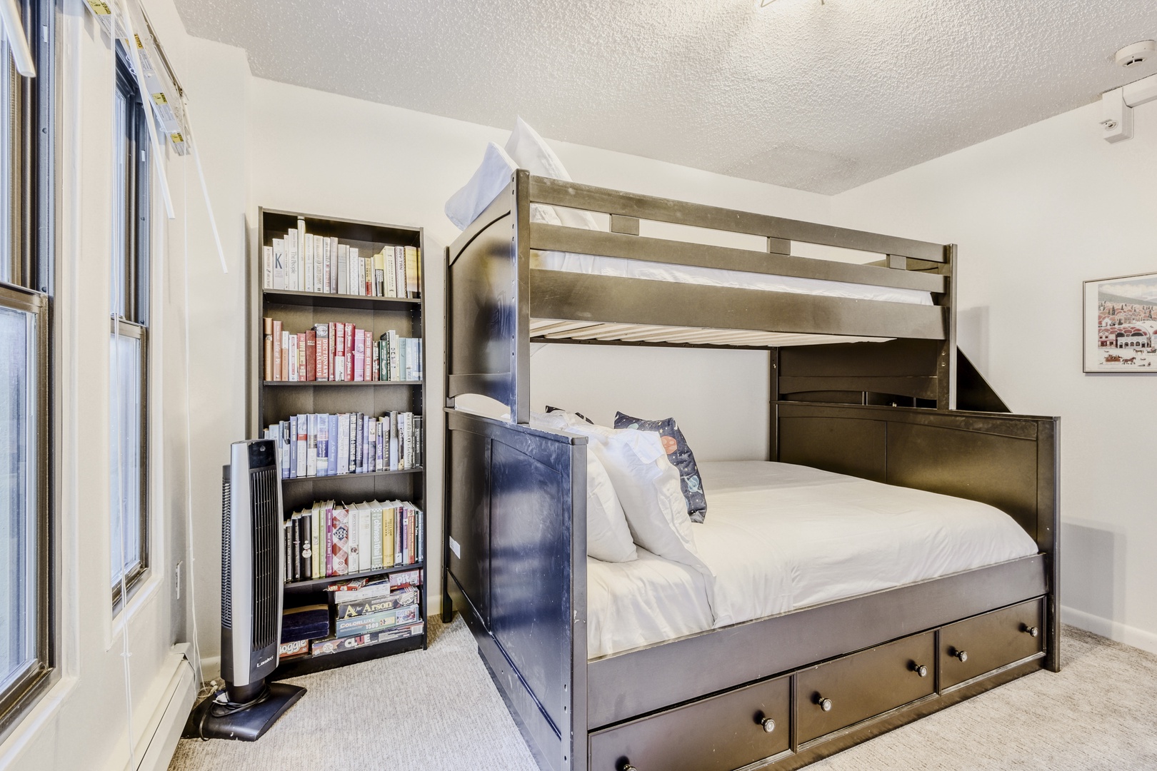 Sleep peacefully in this clever bunk bed setup with built-in storage stairs and cozy blue accents that maximize your space beautifully.